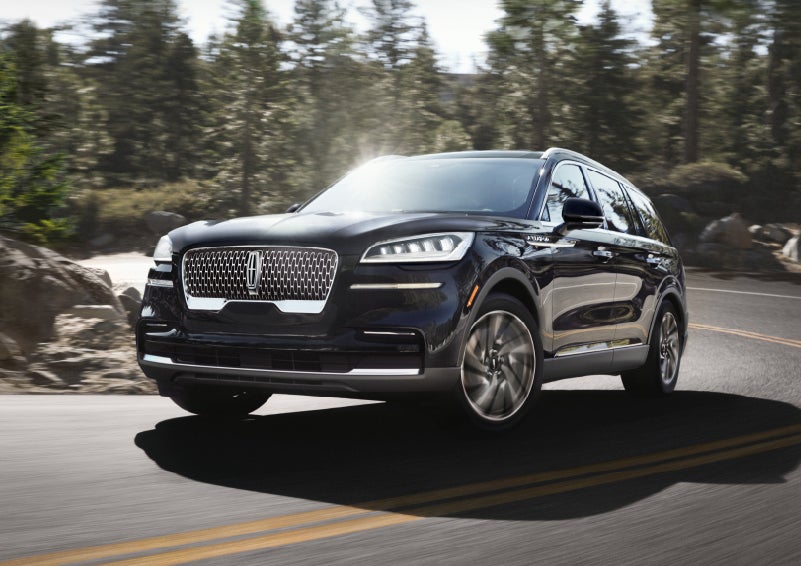 A Lincoln Aviator® SUV is being driven on a winding mountain road | Korum Lincoln in Puyallup WA