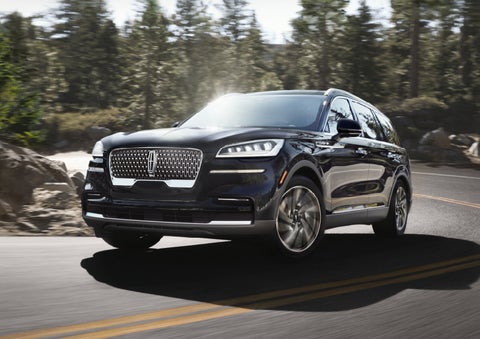 A Lincoln Aviator® SUV is being driven on a winding mountain road | Korum Lincoln in Puyallup WA