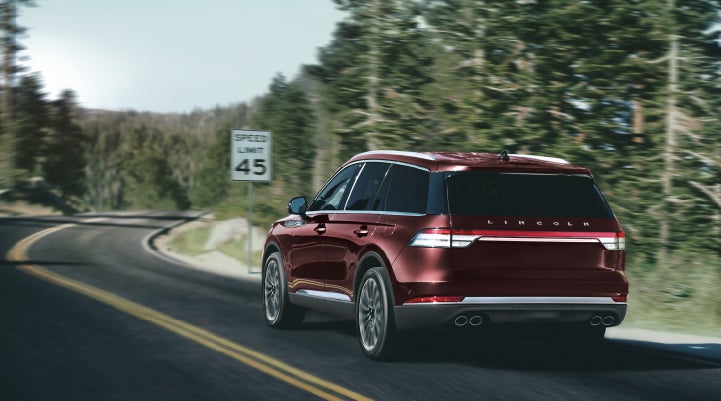 A 2024 Lincoln Aviator® SUV is being driven on a winding mountain road | Korum Lincoln in Puyallup WA