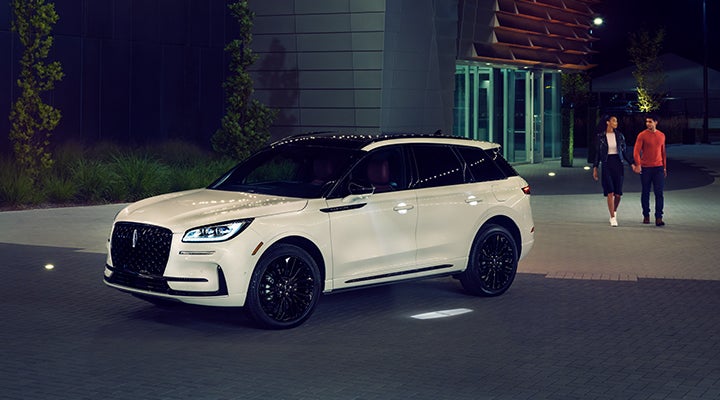 Two people approach a 2024 Lincoln Corsair® SUV featuring the available Jet Appearance Package. | Korum Lincoln in Puyallup WA