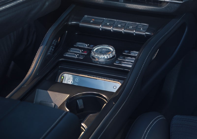 A smartphone is shown charging in the wireless charging pad. | Korum Lincoln in Puyallup WA
