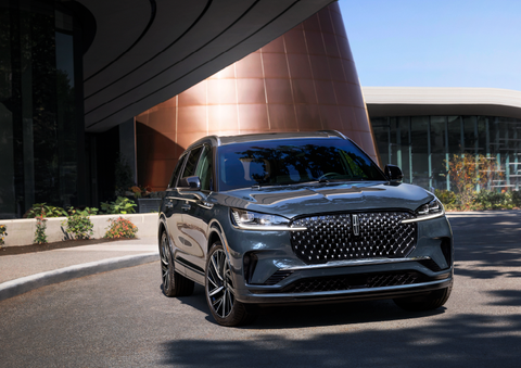 A gray 2025 Lincoln Aviator® SUV is parked outside a modern building with the sun shining. | Korum Lincoln in Puyallup WA
