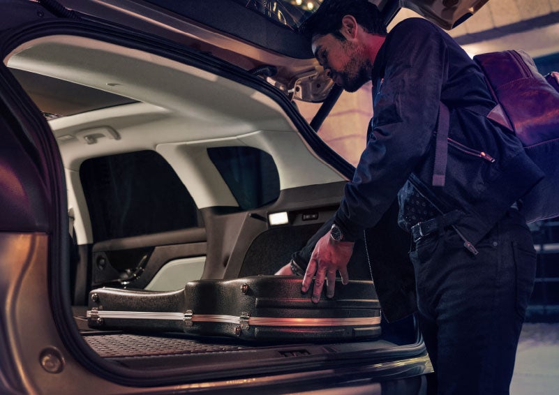 A man is shown loading cargo into the rear of a 2024 Lincoln Corsair® SUV with the second-row seats folded flat. | Korum Lincoln in Puyallup WA