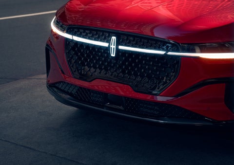 The available front LED light bar and center Lincoln Star logo glow at dusk. | Korum Lincoln in Puyallup WA