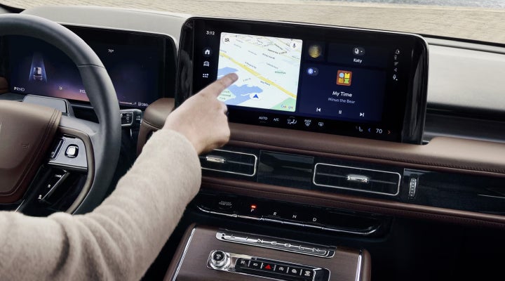 A person is tapping the center display touchscreen of a 2026 Lincoln Aviator® SUV. | Korum Lincoln in Puyallup WA