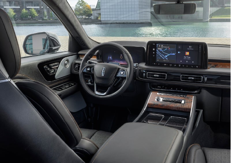 The interior of the 2026 Lincoln Aviator® SUV is shown parked with a view of a harbor through the windshield. | Korum Lincoln in Puyallup WA