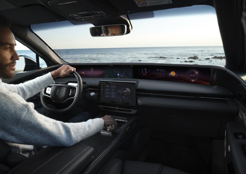 A driver of a parked 2026 Lincoln Nautilus® SUV takes a relaxing moment at a seaside overlook while inside his Nautilus. | Korum Lincoln in Puyallup WA