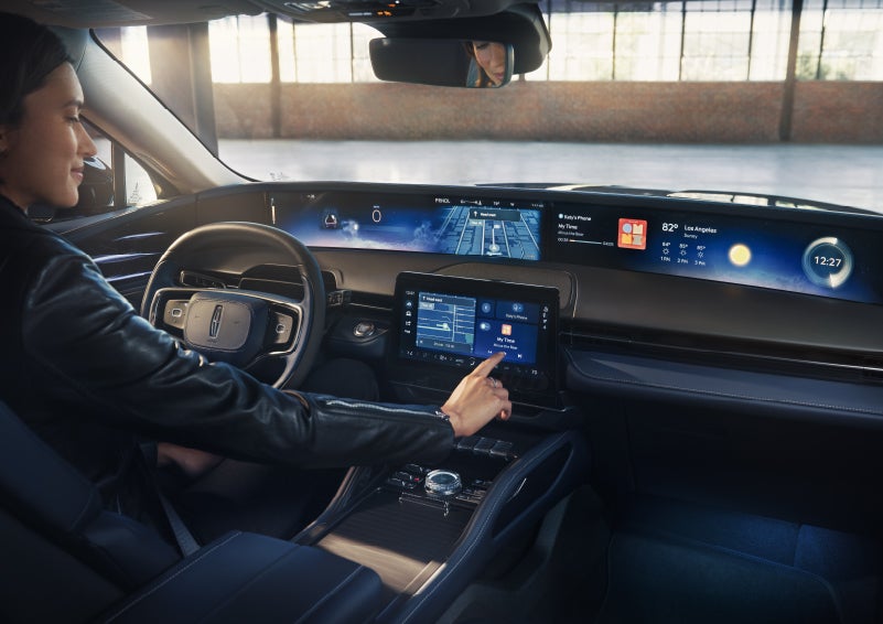 The driver of a 2026 Lincoln Nautilus® SUV interacts with the center touchscreen. | Korum Lincoln in Puyallup WA