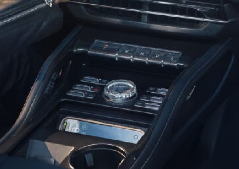 A smartphone is shown charging in the wireless charging pad. | Korum Lincoln in Puyallup WA