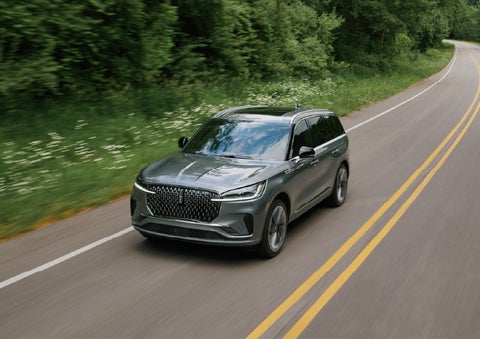 A 2027 Lincoln Aviator® SUV is being driven down a road. | Korum Lincoln in Puyallup WA