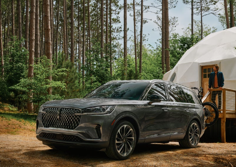 A 2027 Lincoln Aviator® is parked next to a high end glamping site. | Korum Lincoln in Puyallup WA