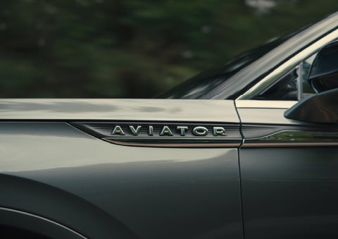 The driver’s side door and fender badging of a gray 2027 Lincoln Aviator® SUV are showcased. | Korum Lincoln in Puyallup WA
