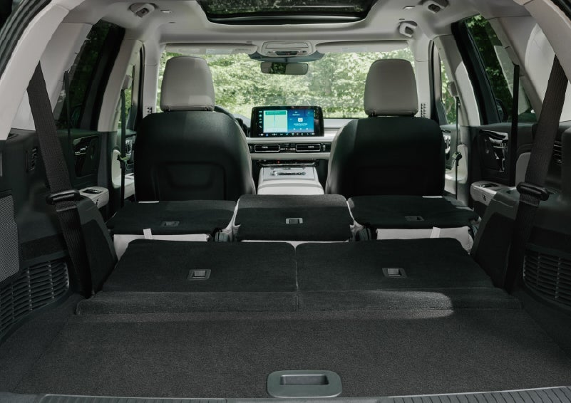 A rear to front view of the interior of a 2027 Lincoln Aviator® Black Label™ SUV shows the third and second rows folded flat | Korum Lincoln in Puyallup WA