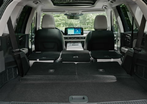 A rear to front view of the interior of a 2027 Lincoln Aviator® Black Label™ SUV shows the third and second rows folded flat | Korum Lincoln in Puyallup WA