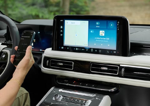 A person pairs thier phone with the center touchscreen of a 2027 Lincoln Aviator® Black Label™ SUV | Korum Lincoln in Puyallup WA